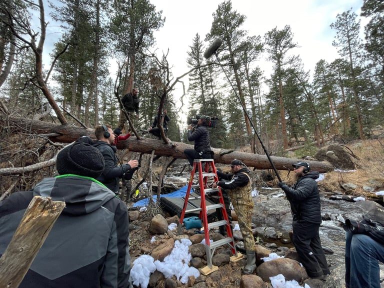 Sound crew booming a scene in the forest