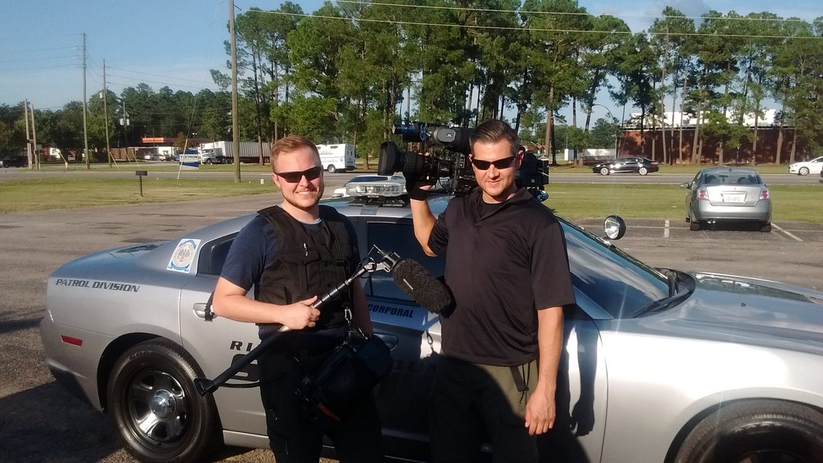Adam Terrell on set with boom microphone